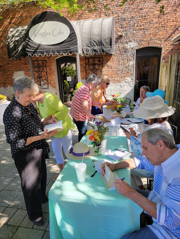 Joe Lewis signs his book